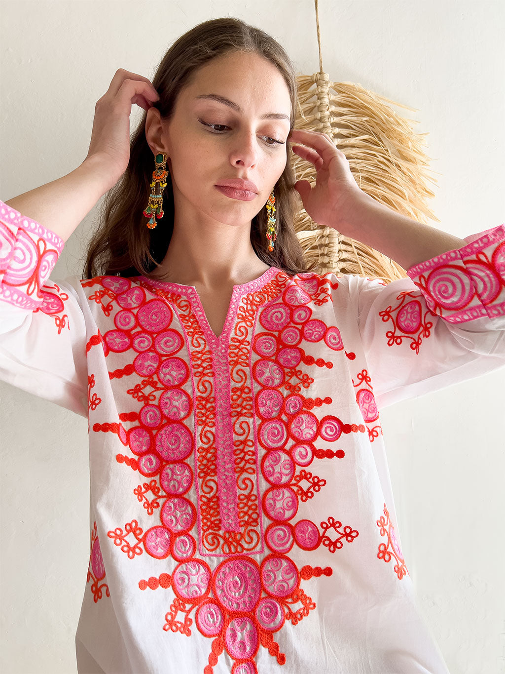 Emilia Embroidered Mini Dress in White. Close-up of pink and red embroidery.