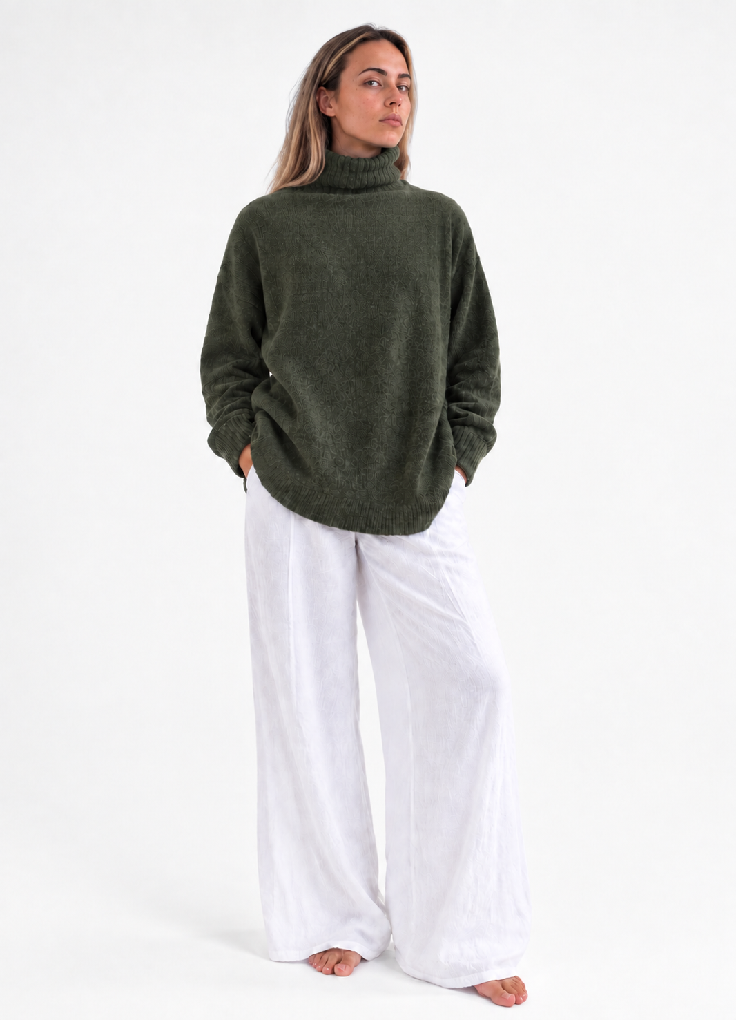 Cozy Turtleneck Sweater in Army Green, front studio view with white trousers.