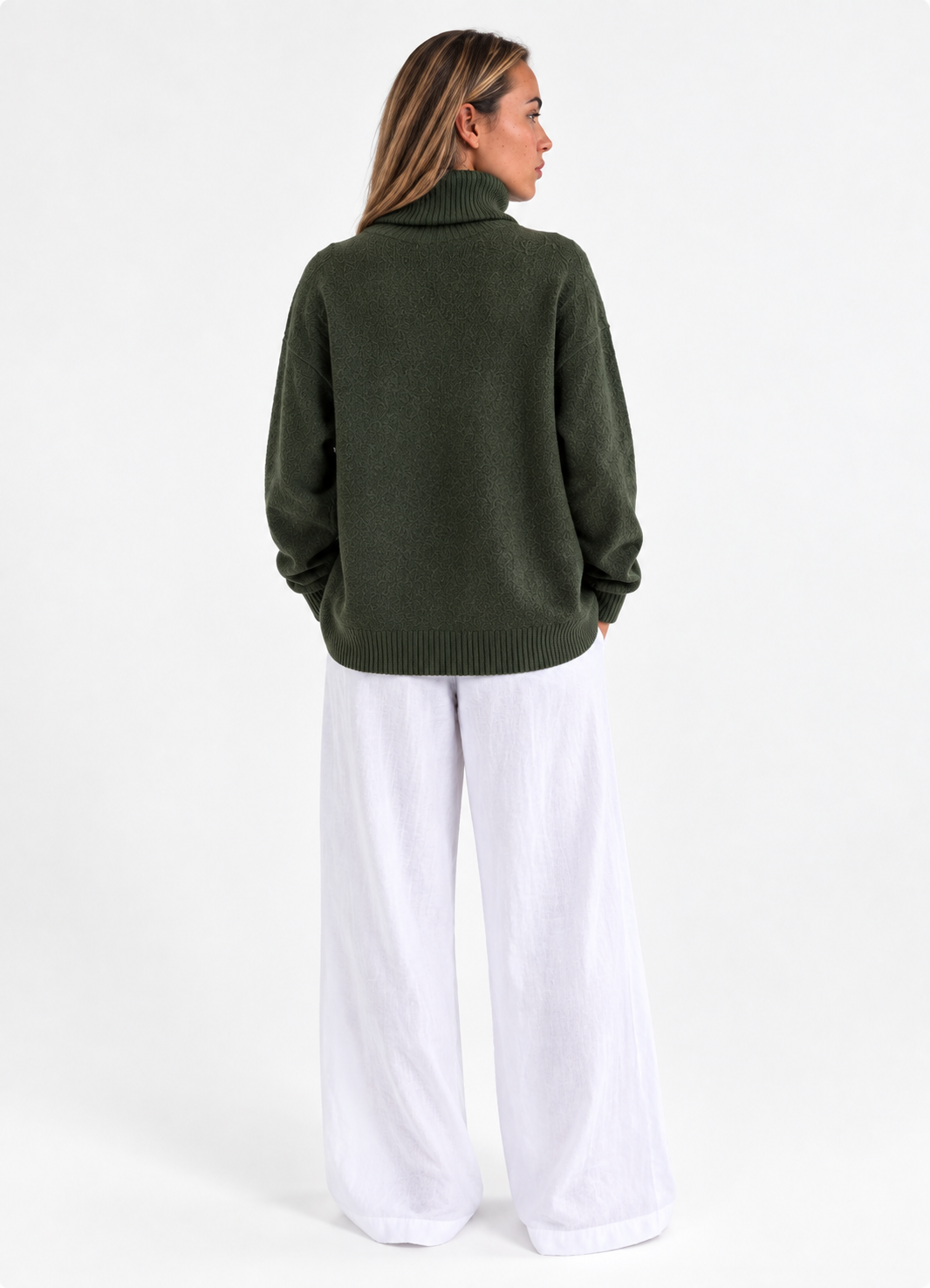 Cozy Turtleneck Sweater in Army Green, back studio view with white trousers.