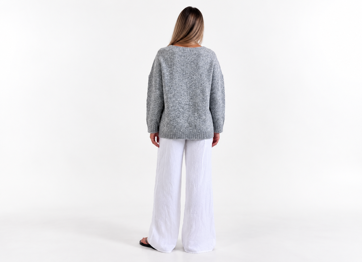 Frost Cardigan in Heather Grey, back studio view with white trousers.