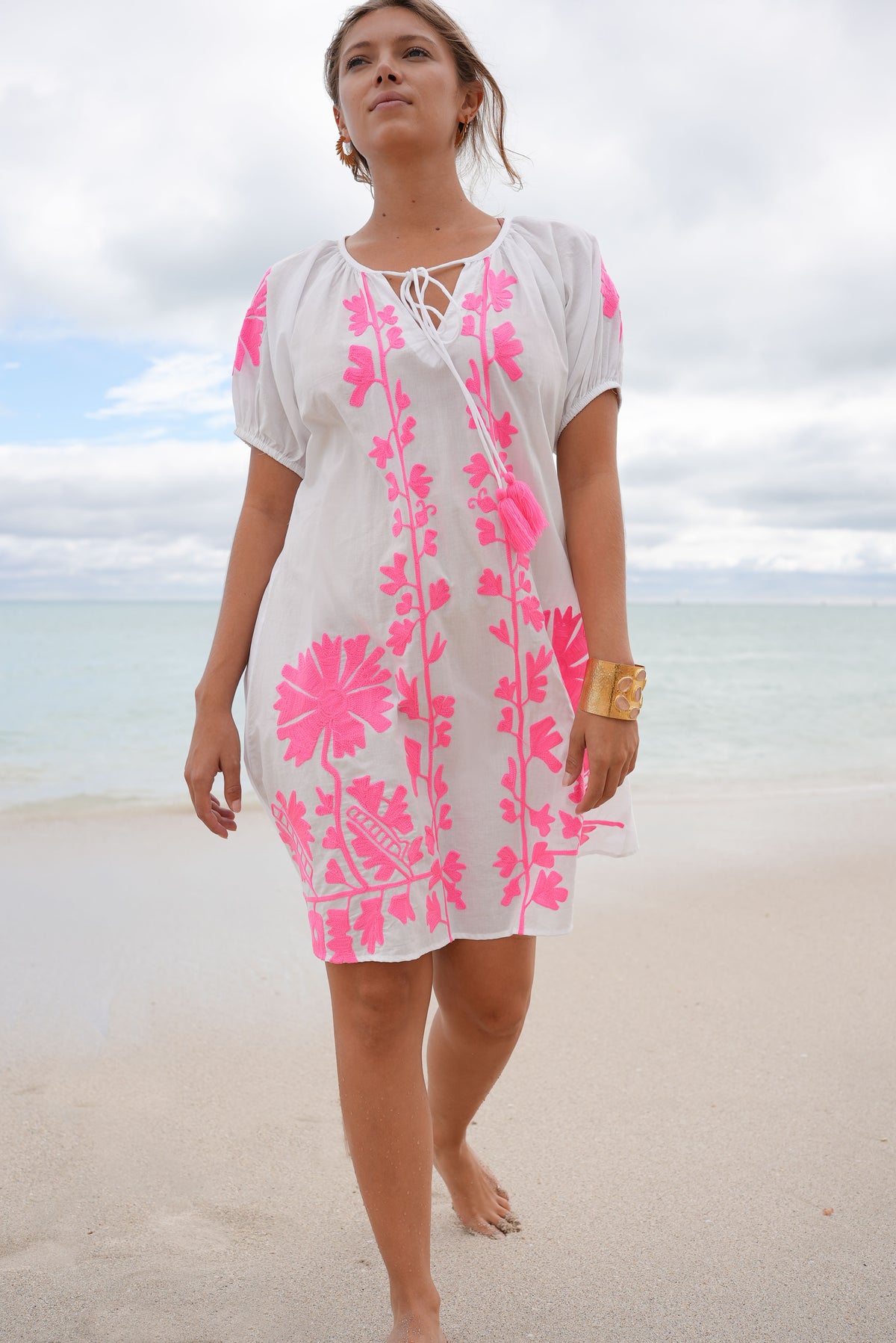 Jessie Embroidered Dress in White and Pink. Closer front view of the embroidery and tassel ties.