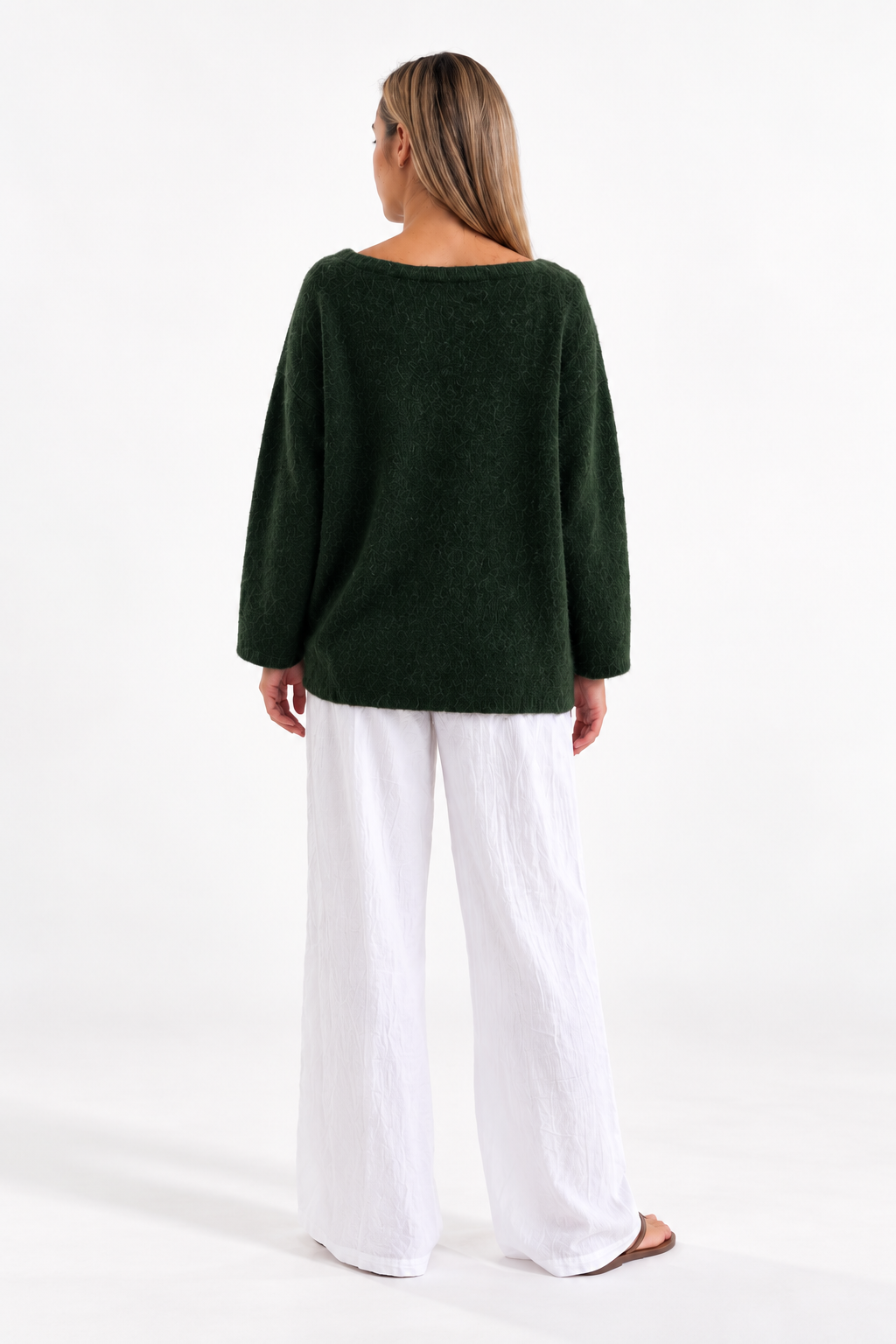 Merry Boatneck Sweater in Army Green, back studio view with white trousers.