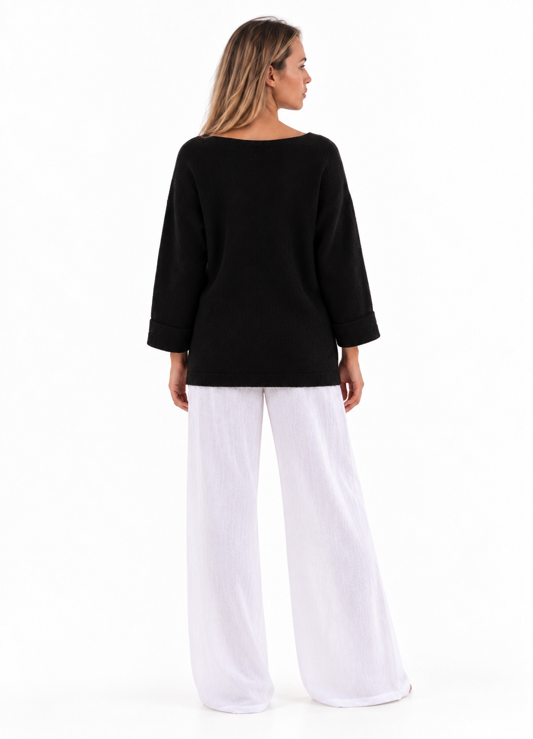 Merry Boatneck Sweater in Black, back studio view with turned-back cuffs.