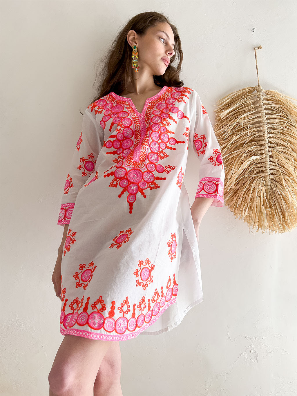 Emilia Embroidered Mini Dress in White. Angled front view.