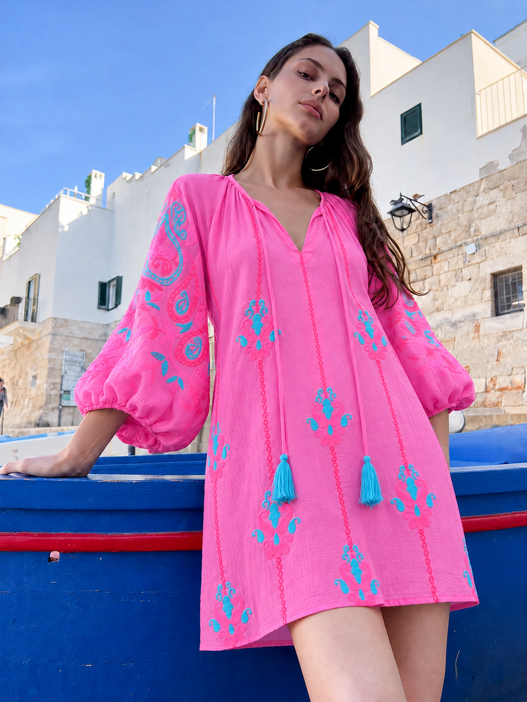Risa Tunic Pink Multi — pink embroidered tunic, front view by the harbor