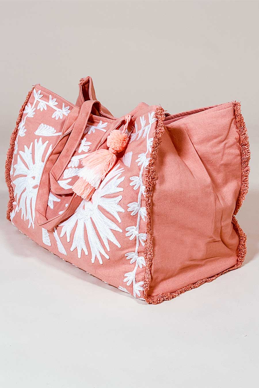 beautiful ample sized beach in coral with bold embroidery. Made from cotton canvas by Debbie Katz